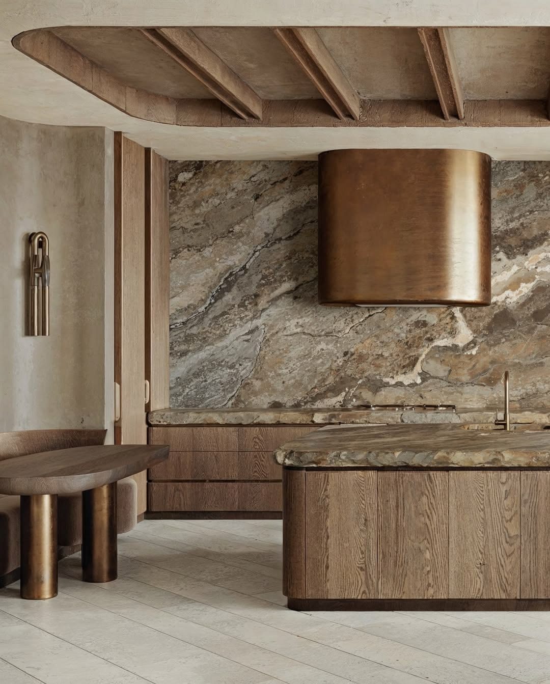 Oak kitchen with a bronze hood and stone island