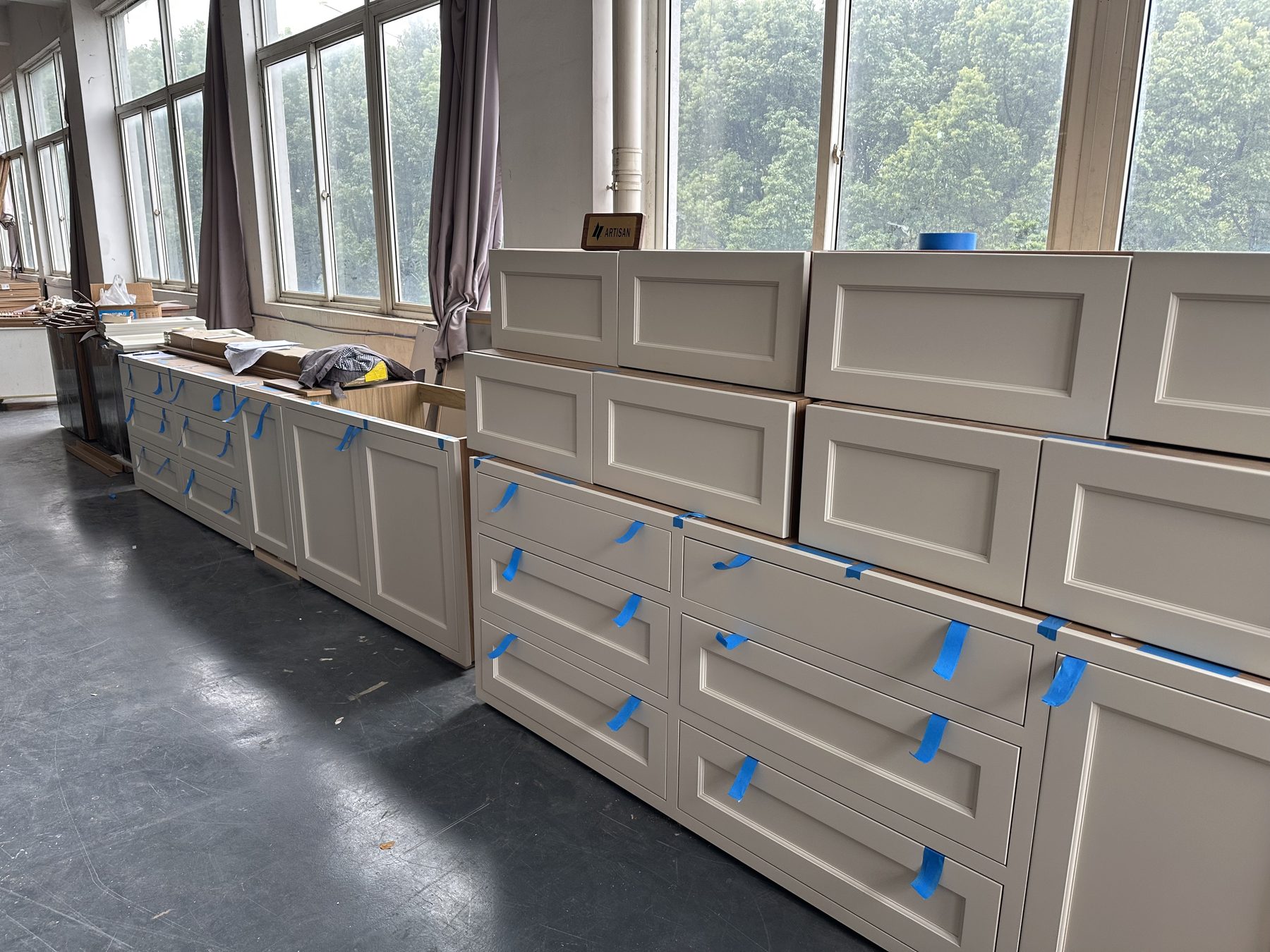 Painted cabinet doors stacked at the mill